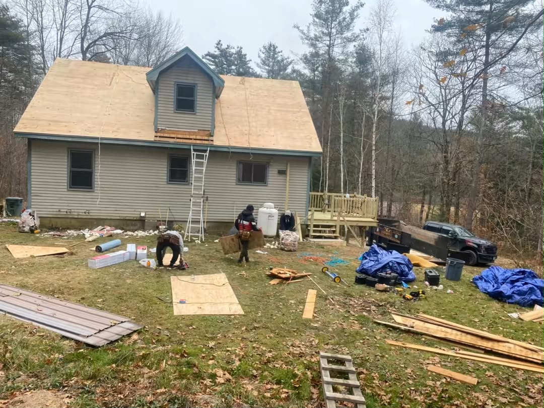 Roofing crew installing new shingles in New Hampshire